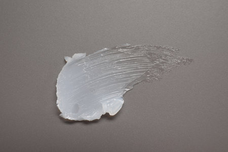 Face cream on gray background, top viewの写真素材