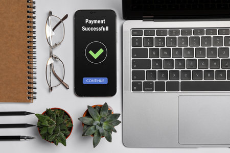 Online payment system. Smartphone with open application on table, top view