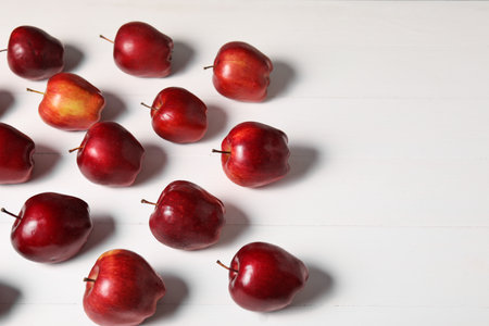 Fresh red apples on white wooden table. Space for textの写真素材