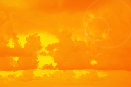 Orange sky with clouds during hot summer weather