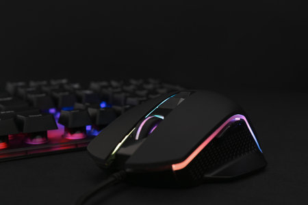 Computer mouse and RGB keyboard on black background, closeupの写真素材