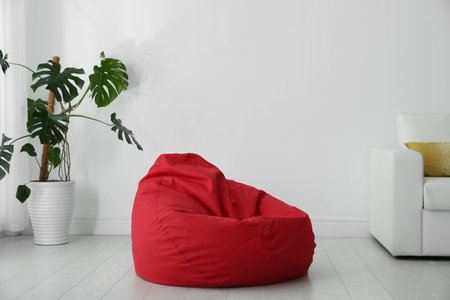 Red bean bag chair on floor in roomの写真素材