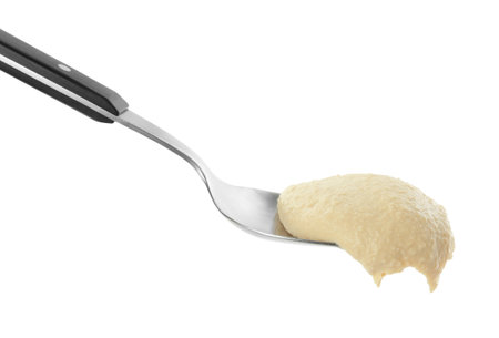 Spoon with delicious hummus isolated on whiteの写真素材