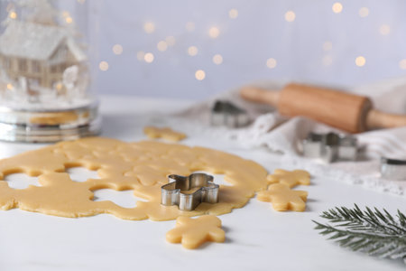 Making cookies. Raw dough and cutter on white tableの写真素材