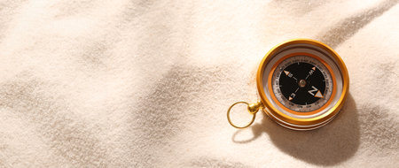 Compass on sand. Banner design with space for textの写真素材