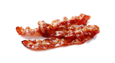Slices of tasty fried bacon isolated on whiteの写真素材