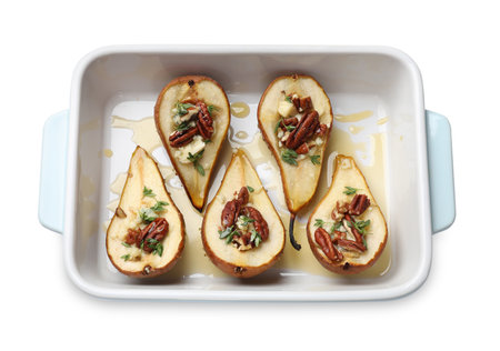 Tasty baked pears with nuts, blue cheese, thyme and honey in baking dish on white background, top viewの写真素材