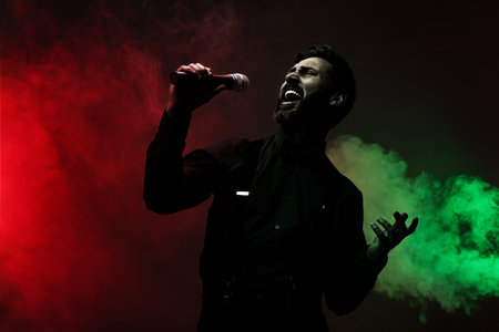 Singer with microphone in neon lights on stageの写真素材