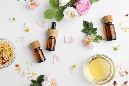 Aromatherapy. Essential oils, flowers and petals on white background, flat layの写真素材