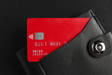 Credit card in leather wallet on black background, top viewの写真素材