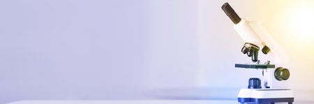 Microscope on blurred background. Banner design with space for text