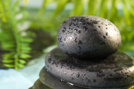 Wet spa stones on blurred background, closeupの写真素材