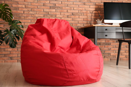 Red bean bag chair on floor in roomの写真素材