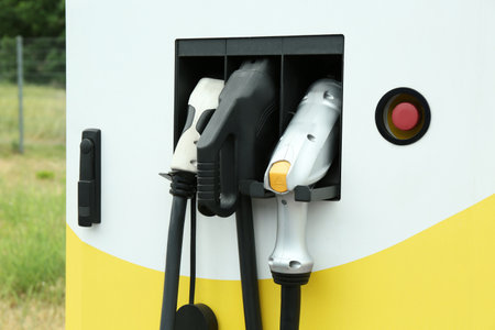 Modern electric vehicle charging station with plugs outdoorsの写真素材