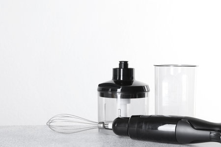 Hand blender kit on gray table against white background, space for textの写真素材