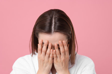 Woman suffering from hair loss problem on pink backgroundの写真素材