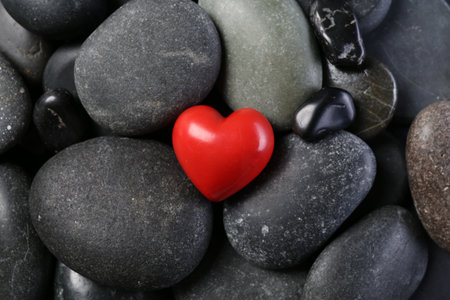 Red decorative heart on pebble stones, top viewの写真素材