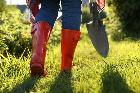 Farmer walking with shovel on sunny day, closeupの写真素材