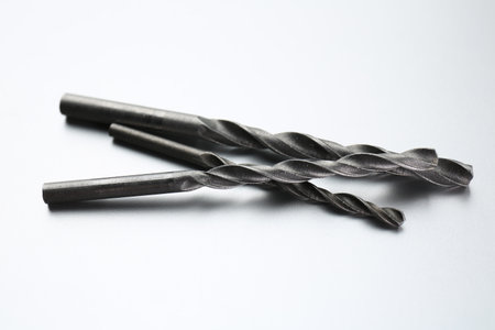 Different drill bits on light gray background
