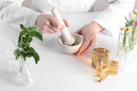 Aromatherapy product. Scientist developing essential oils at white table in laboratory, closeupの写真素材