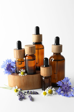 Aromatherapy. Different essential oils and flowers on white backgroundの写真素材