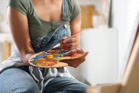 Woman drawing picture with paint in studio, closeupの写真素材