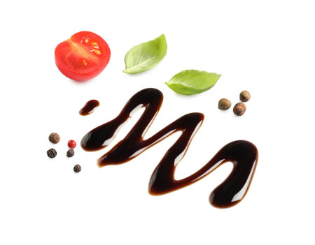 Delicious balsamic vinegar, tomato, basil and peppercorns isolated on whiteの写真素材