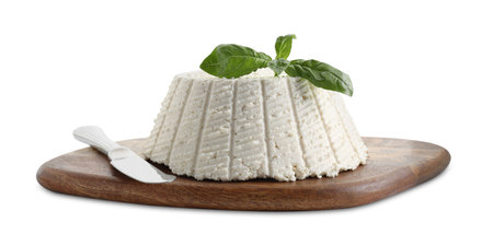 Tasty ricotta (cream cheese), basil and knife isolated on whiteの写真素材