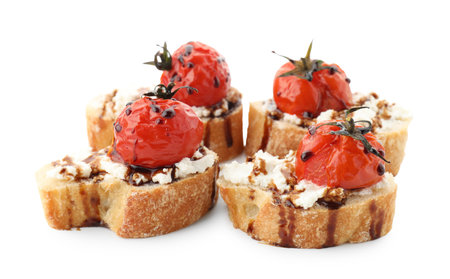 Delicious bruschettas with ricotta cheese, tomatoes and balsamic sauce isolated on white