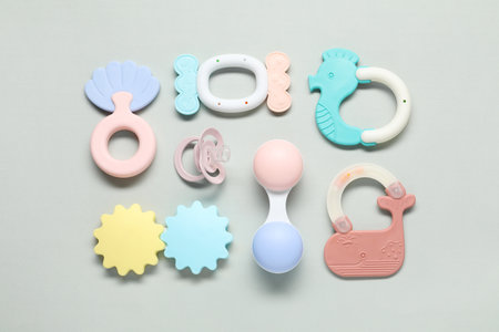 Different baby rattles on light background, flat layの写真素材