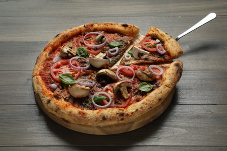 Tasty pizza with mushrooms, basil and tomatoes on wooden table, closeupの写真素材