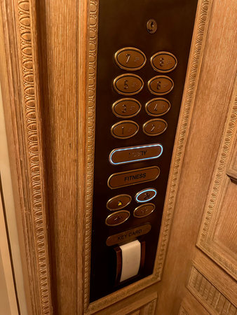 Elevator with golden buttons in luxury hotel
