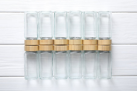 Empty glass jars on white wooden table, top viewの写真素材