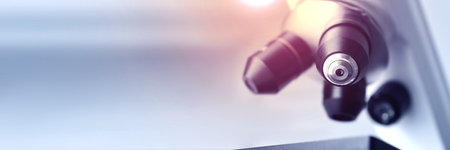 Microscope on blurred background, closeup. Banner design with space for textの写真素材