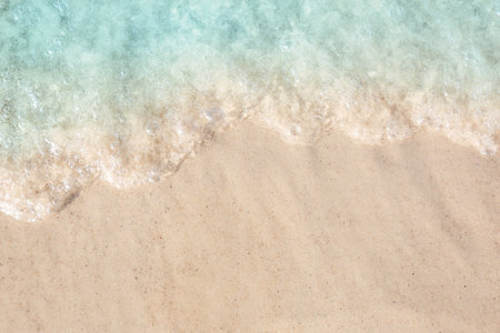 Sea waves rolling on beautiful sandy beach, top view. Summer vacationの写真素材