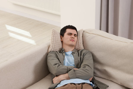 Man suffering from abdominal pain at home