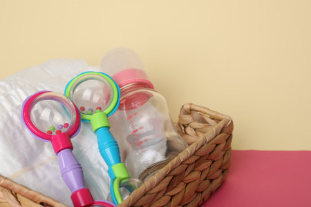 Baby accessories in box on color background, closeup