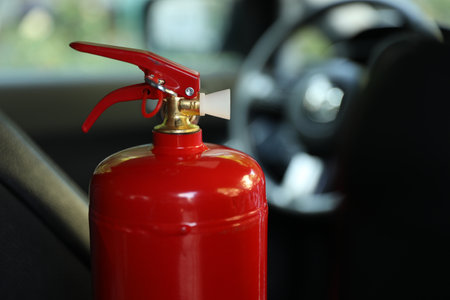 Red fire extinguisher in automobile, closeup. Car safety equipmentの写真素材