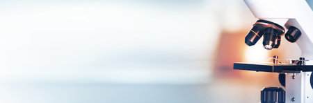 Microscope on blurred background, closeup. Banner design with space for text