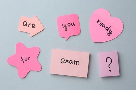 Sticky notes with question Are You Ready For Exam and stationery on grey background, flat layの写真素材