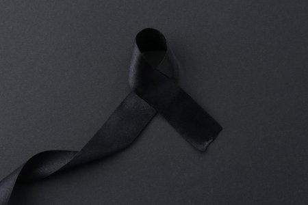 Black awareness ribbon on color background, top viewの写真素材