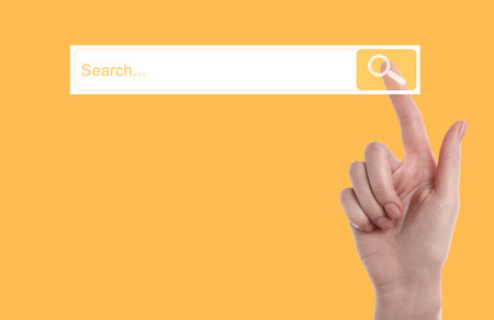 Woman using search bar on virtual screen against orange background, closeupの写真素材