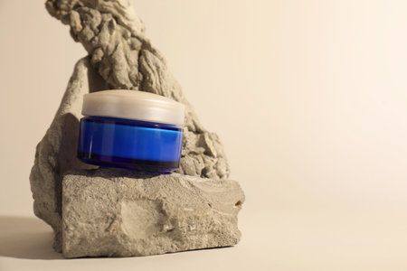 Stylish presentation of facial cream on beige background, space for textの写真素材