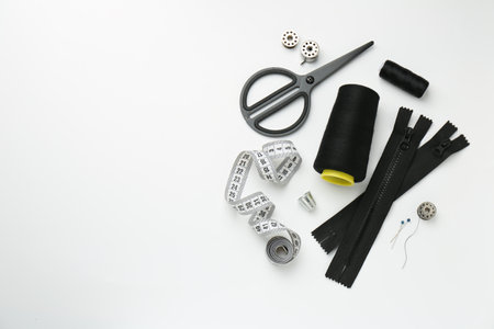 Flat lay composition with different sewing supplies on white background. Space for textの写真素材