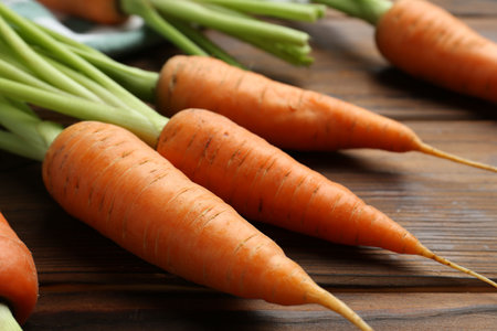 Tasty ripe juicy carrots on wooden table, closeupの写真素材