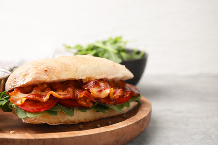 Tasty sandwich with bacon on grey table, closeup. Space for textの写真素材