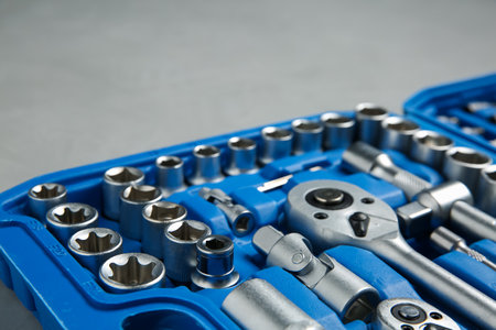 Different auto mechanic's tools in plastic box on gray table, closeupの写真素材