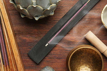 Flat lay composition with incense sticks on wooden table. Om ligatureの写真素材