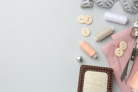 Flat lay composition with different sewing supplies on light gray background. Space for textの写真素材