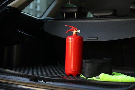 Red fire extinguisher in trunk. Car safety equipmentの写真素材